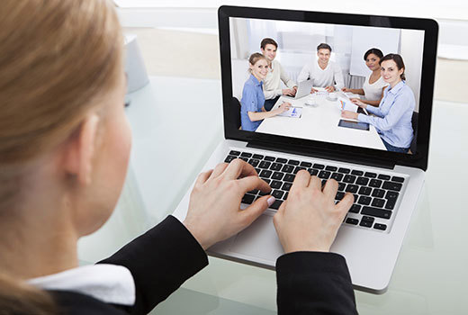 Woman video conferencing a meeting on her laptop