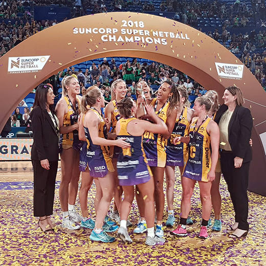 Sunshine Coast Lightning players and coaches celebrate their grand final win over the West Coast Fever