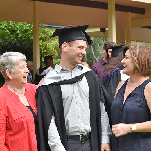 Gympie’s Owen Dugdale celebrates his USC graduation with grandmother Maureen Rush and mother Debra Dugdale