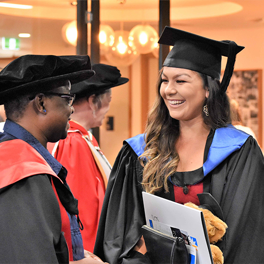 USC Lecturer in Social Work Dr Kate Jonathan congratulates new Human Services graduate Christielle Van Baars at USC’s first Fraser Coast graduation ceremony in April last year.  