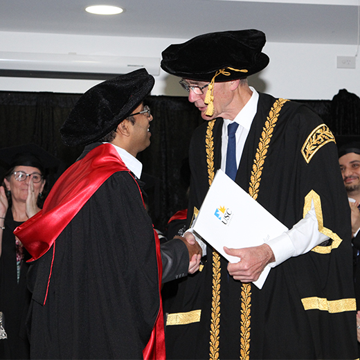 Ratna Paudyal receives his PhD from USC Chancellor Sir Angus Houston at a USC graduation ceremony in Hervey Bay.
