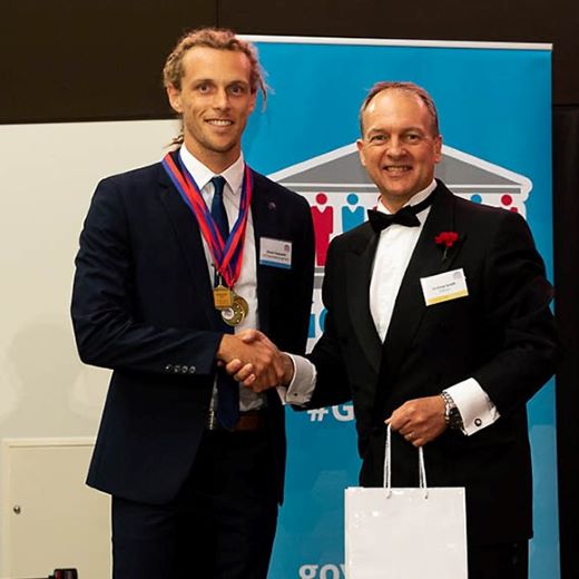 USC student Shaun Hayward of Currimundi receiving an award on behalf of his team from Infosys Senior Vice-President Andrew Groth at the GovHack International Red Carpet Awards in Canberra.