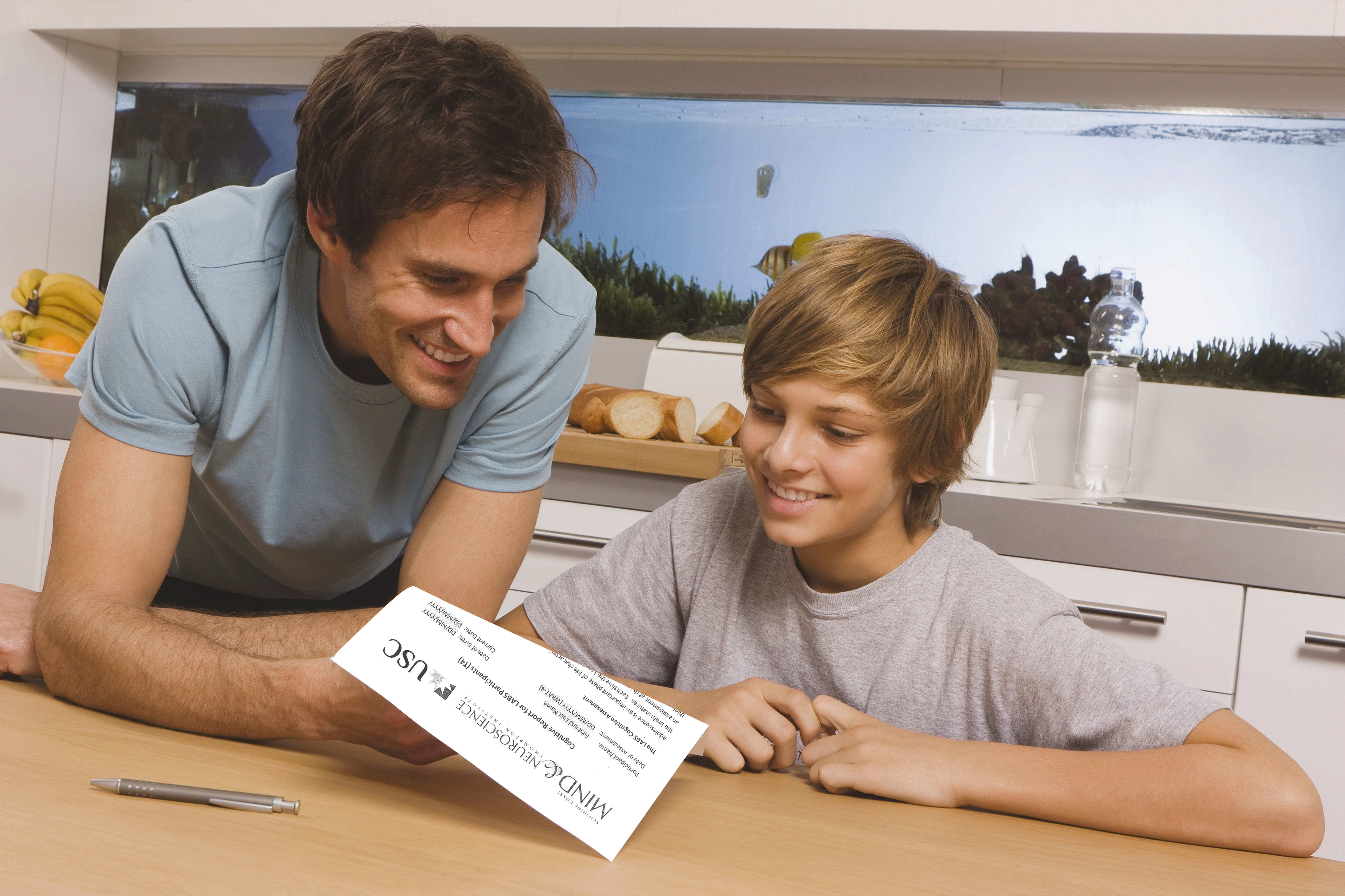Father and son looking over paperwork