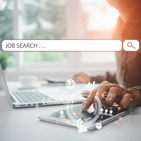 Stock image of job search on computer and phone