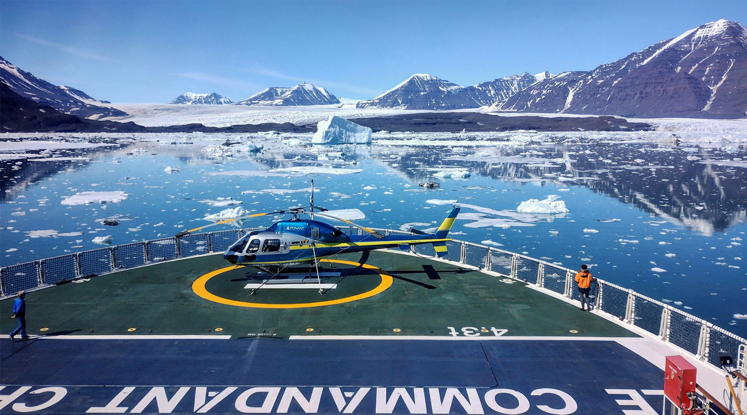 helicopter on top of launchpad on large sea vessel 