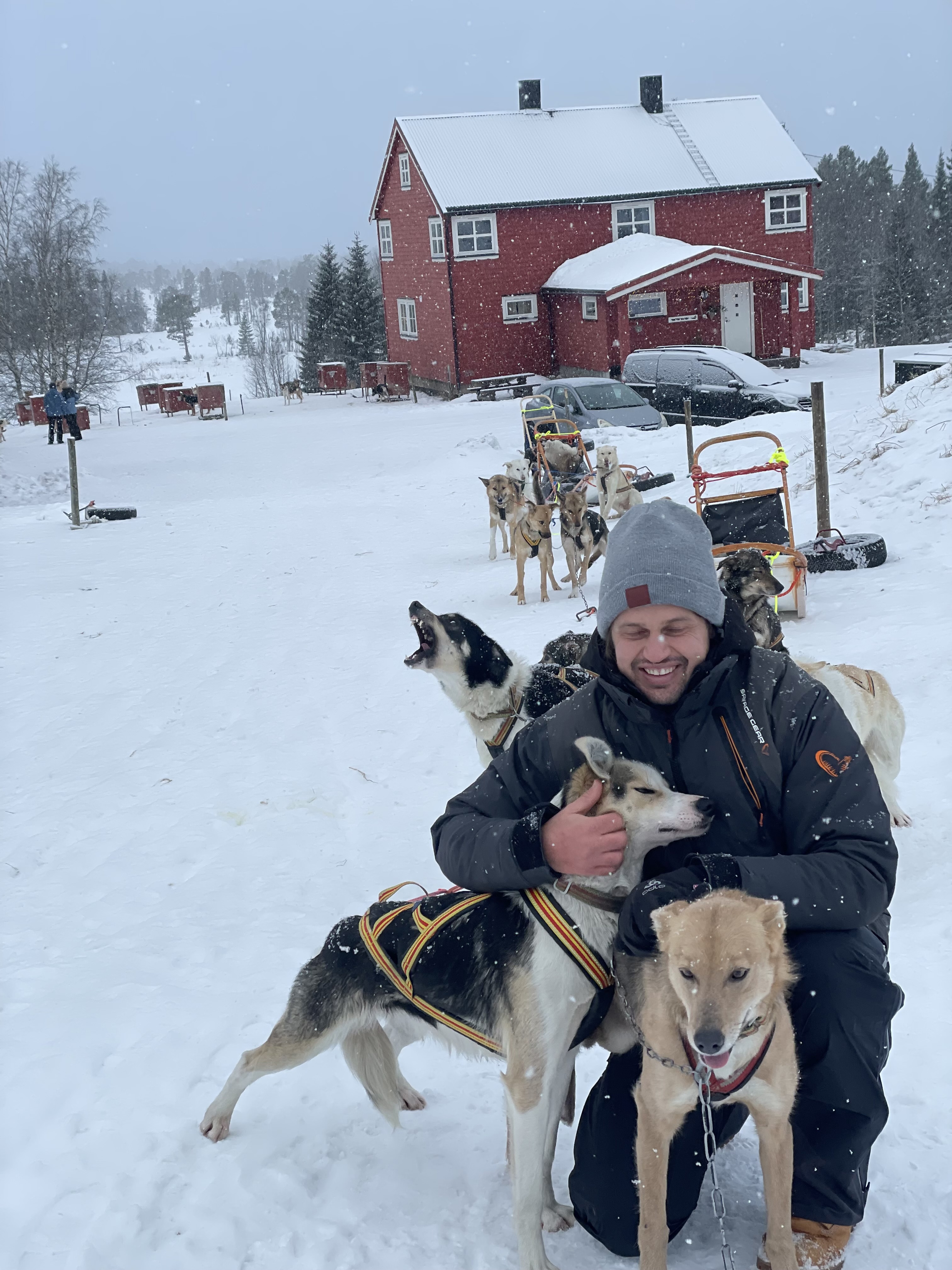 Jack Barden playing with sled dogs in Norway.