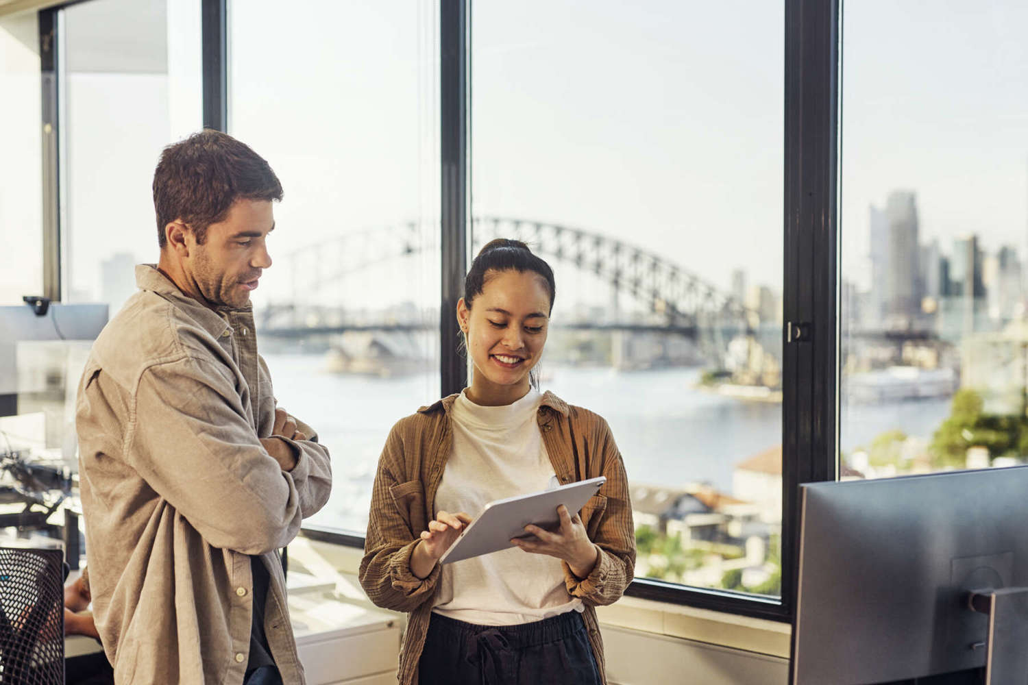 Two Australian Professionals Collaborating In A Sydney Office