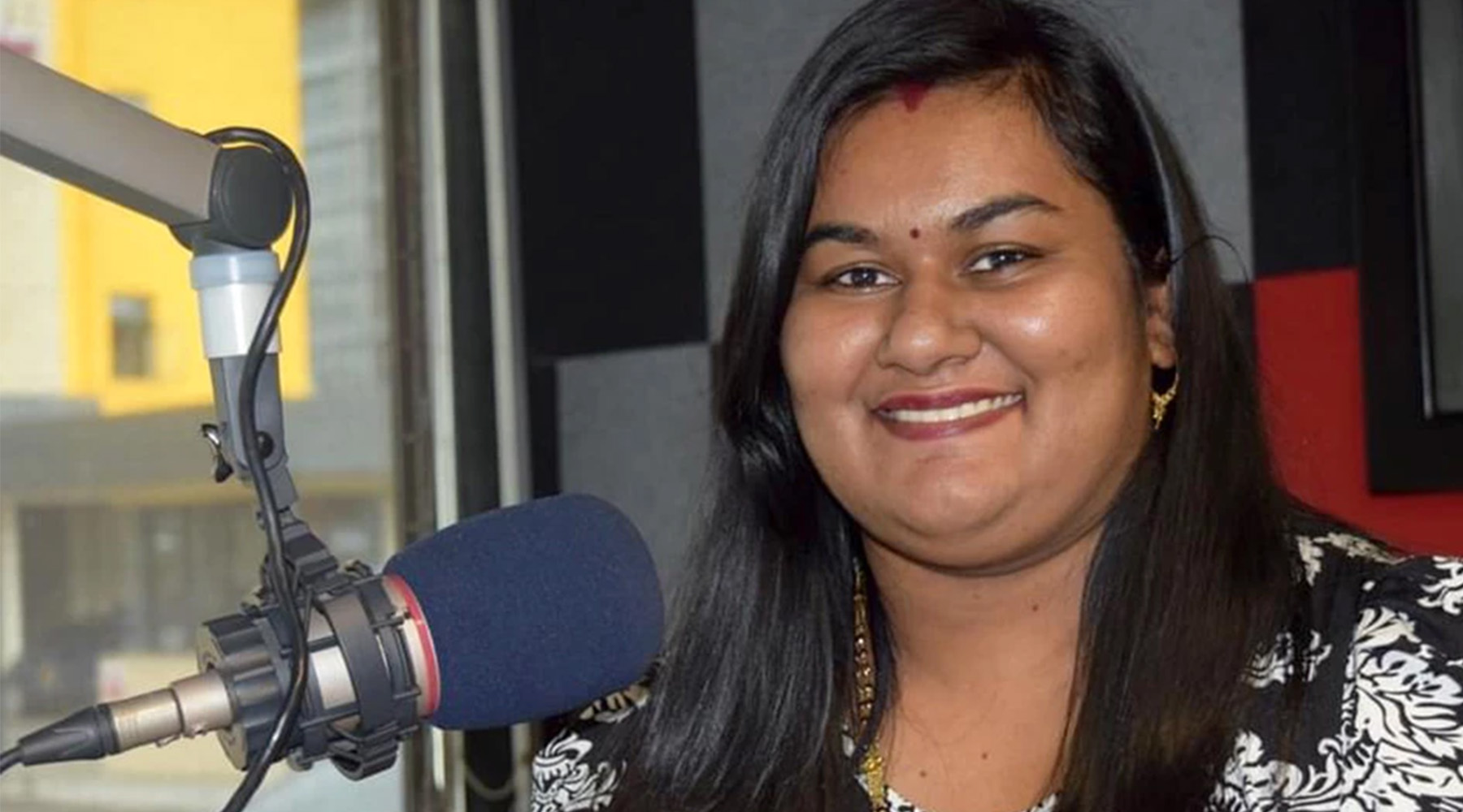 Radio Jockey Joselyn In front of microphone in Fiji 