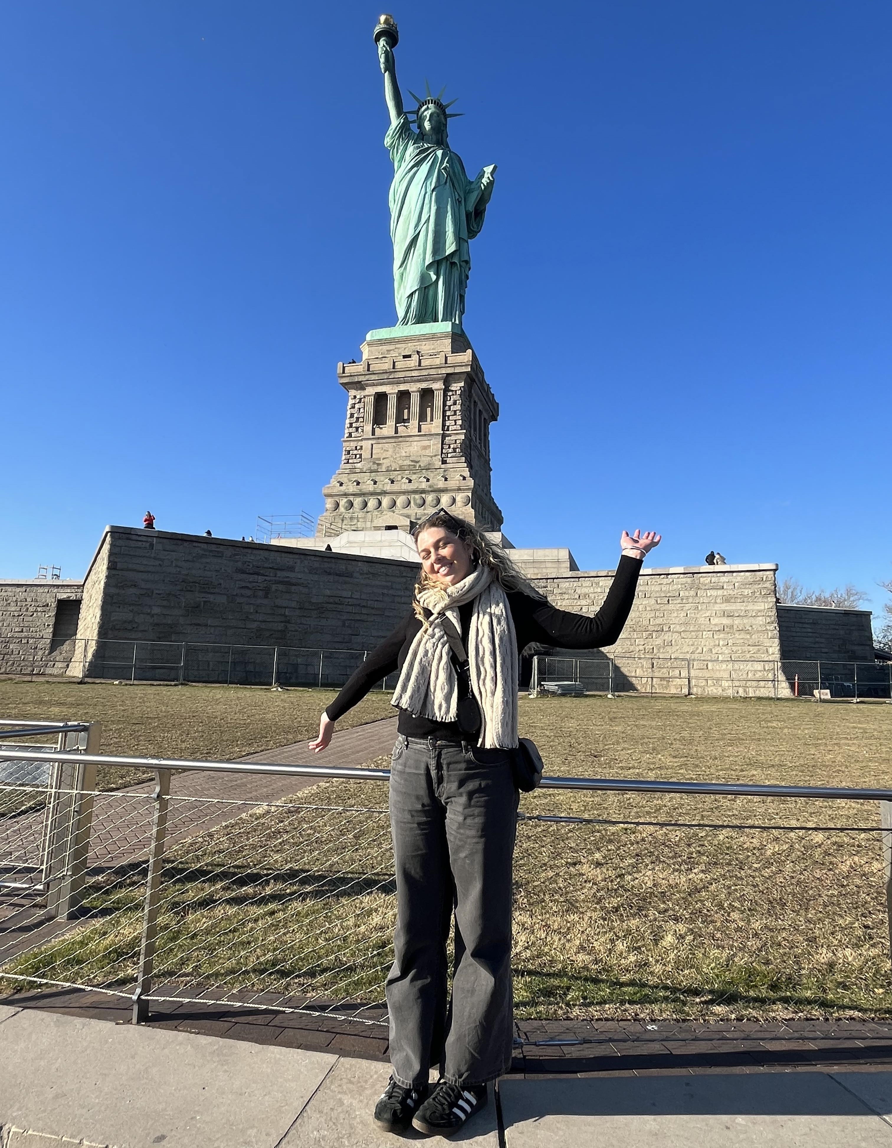 Student in front of Statue of Liberty
