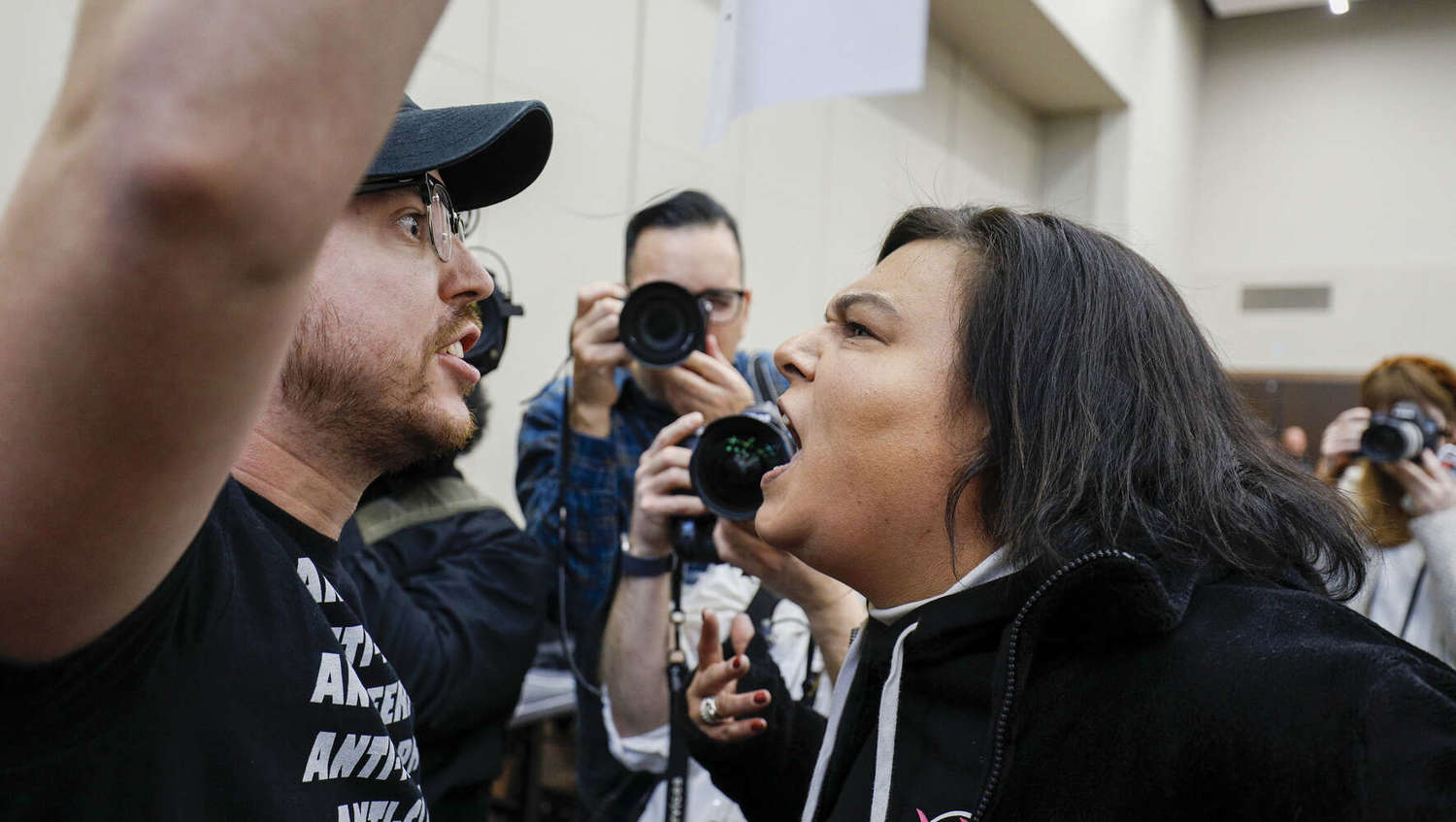  Protestors with opposing views shout at each other