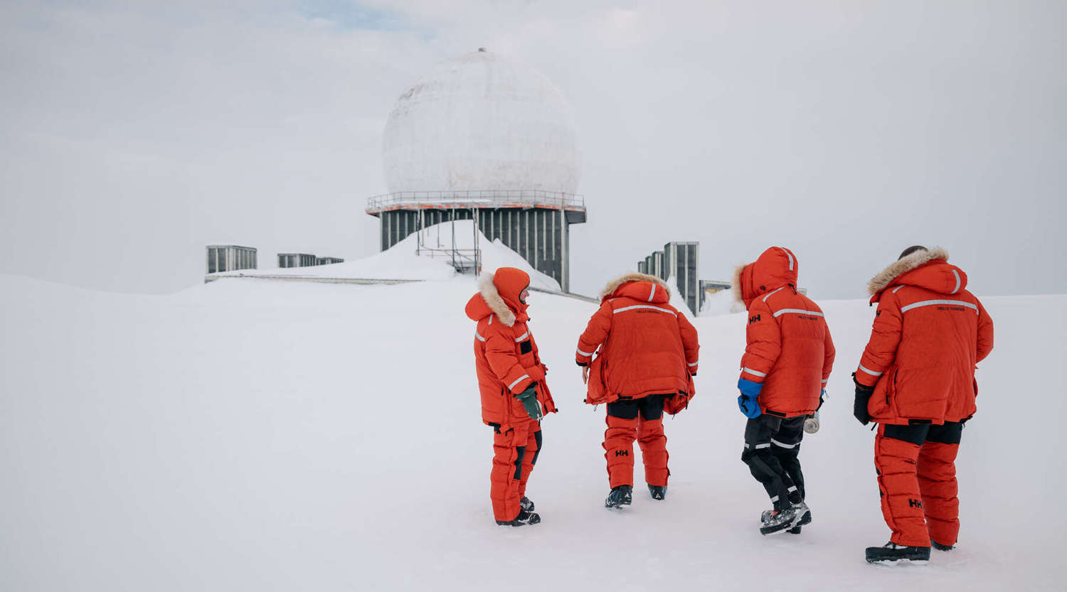 group of scientists gathered outside abandoned research facility