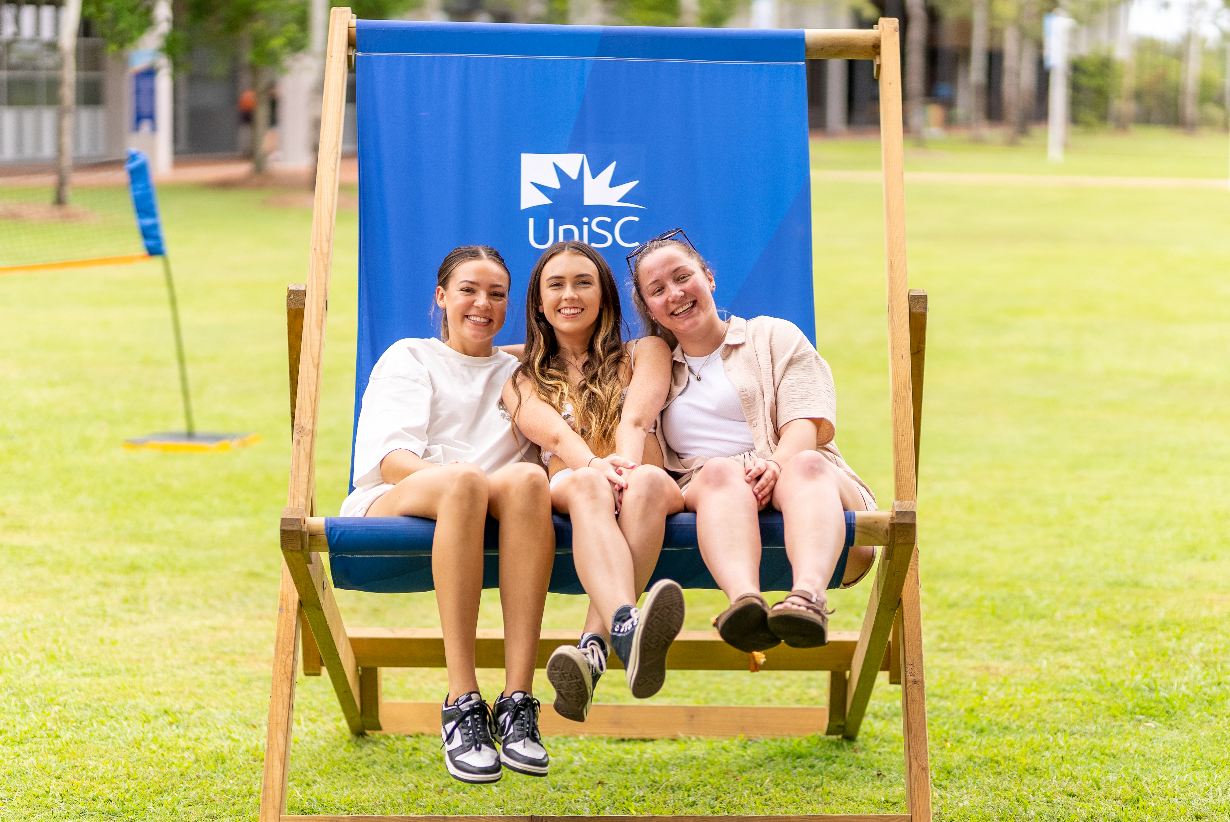 Students sitting together in a big chair