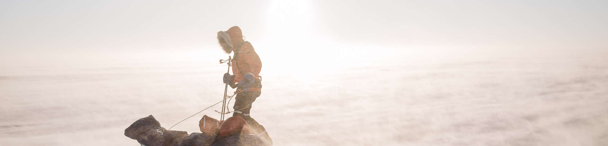 person with sled of equipment