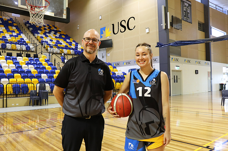 USC's women's basketball coach Warwick Wilson with student Taisha White